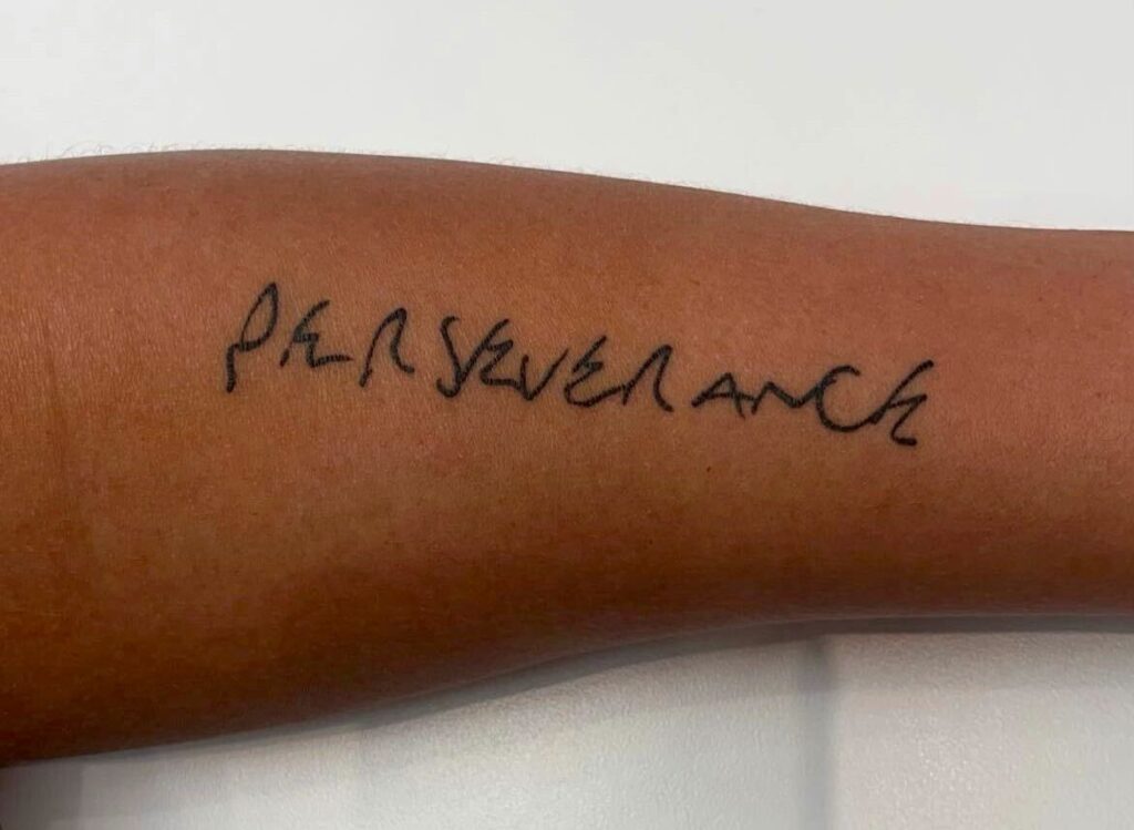 Photograph of Faith's arm that says "perseverance".